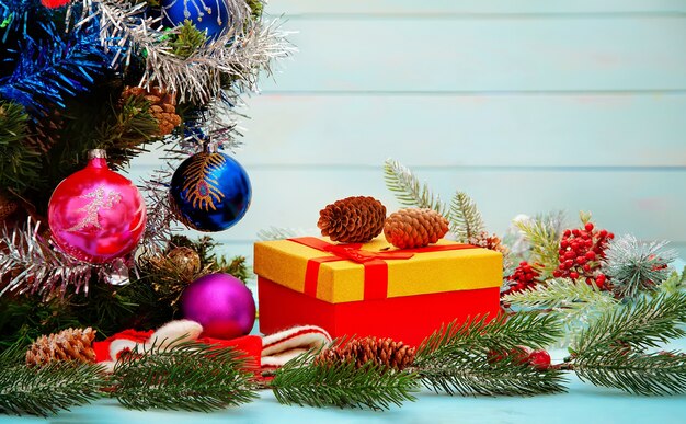 Christmas tree, gift and decorations on blue table