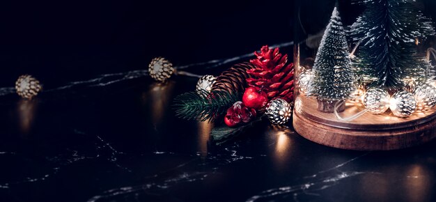 Christmas tree and glowing light string and pine cone and mistletoe decoration 