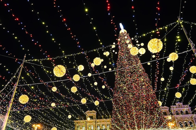 Christmas tree glows on the square in the city Evening night illumination