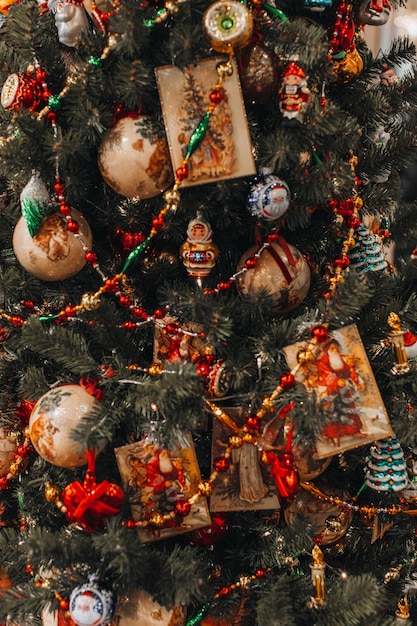 Christmas tree green branches decorated with golden festive star and vintage garlands New year