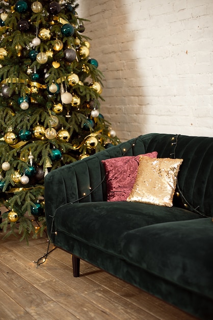 Christmas tree and a green sofa with cushions