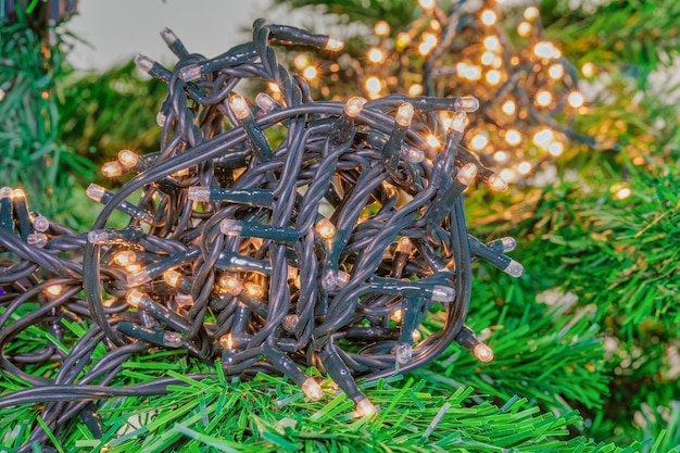 Christmas tree indoors fairy lights ball illuminating with light effect warm lights background.