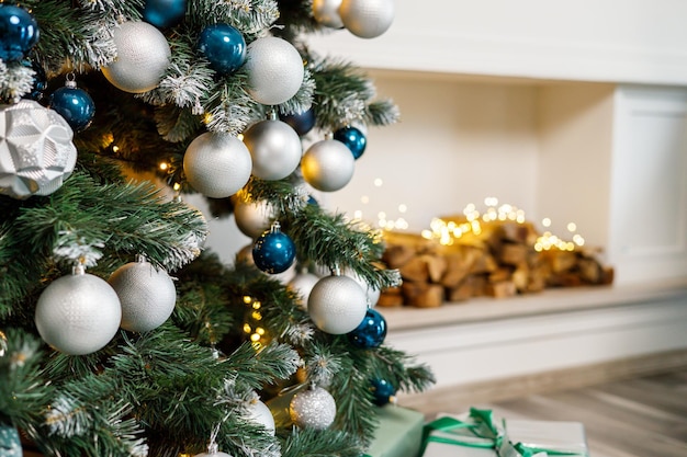 The Christmas tree is decorated for Christmas Beautifully decorated house with silver white and Christmas tree and presents A magical time New Year