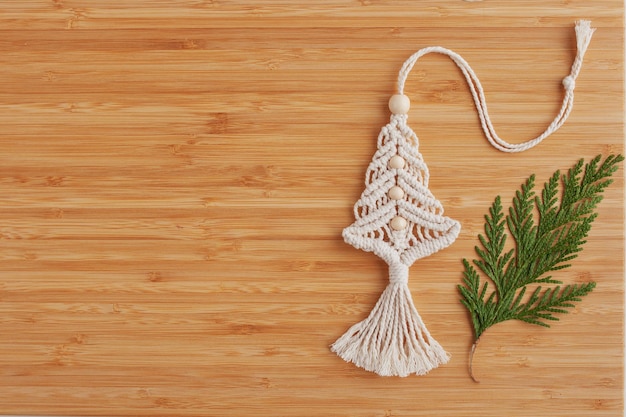 Christmas tree macrame toys on wooden boad Natural materials cotton thread wood beads and stick Eco decorations ornaments hand made decor Winter and New Year holidays