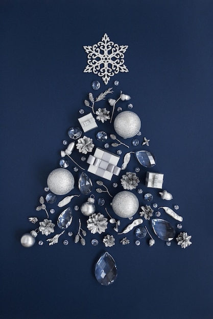 Christmas tree made of crystals and silver New Year decorations on dark blue