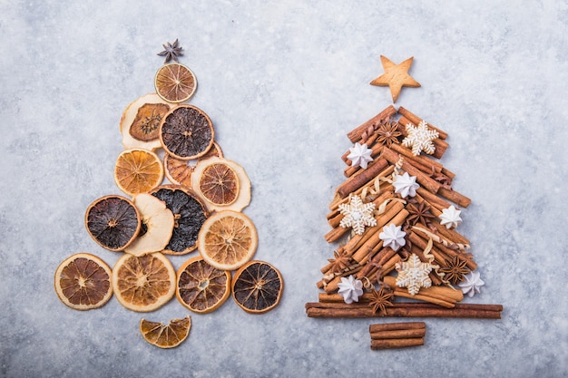 Christmas tree made of dried oranges and cinnamon with traditional gingerbread cookies