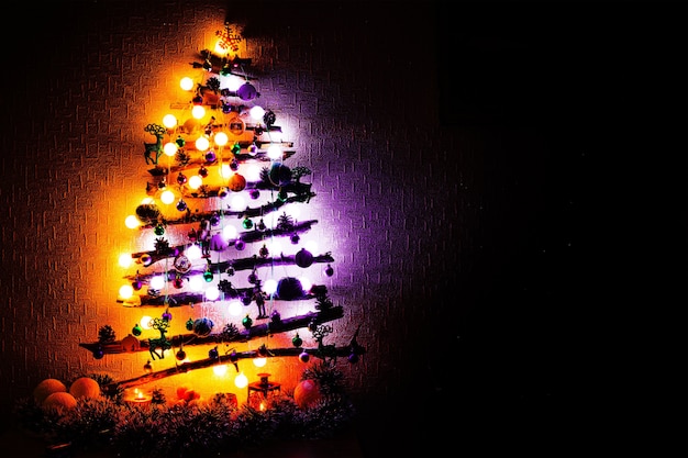 Christmas tree made from sticks with purple orange lights