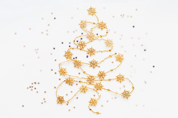 Christmas Tree made of golden snowflake garland with silver star confetti.