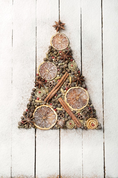 Christmas tree made of spices on wooden background