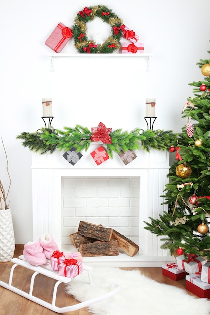 Christmas tree near fireplace in room