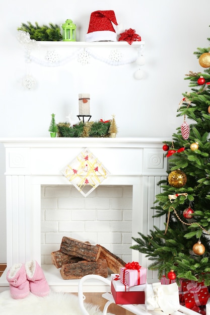 Christmas tree near fireplace in room