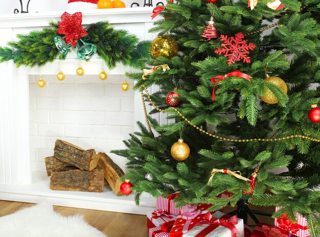 Christmas tree near fireplace in room