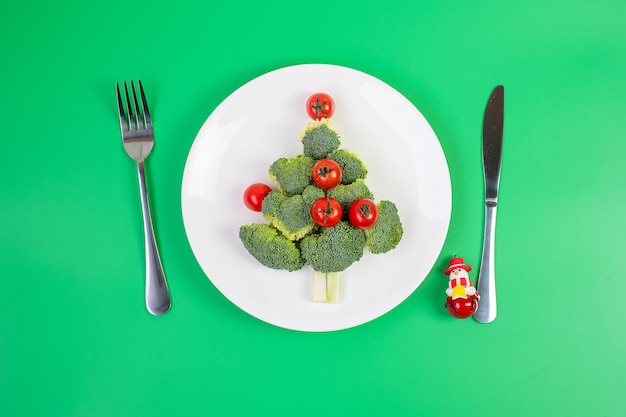 Christmas tree of organic vegetables on white plate