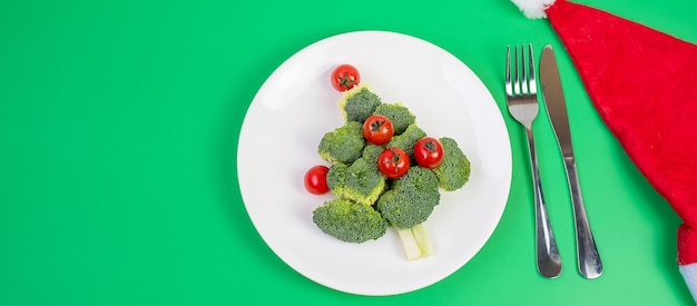 Christmas tree of organic vegetables on white plate