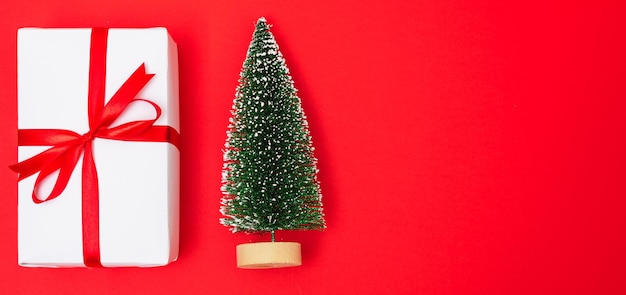 Photo christmas tree and present on red background