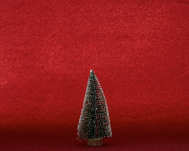 Photo christmas tree on red background copy space for text for idea