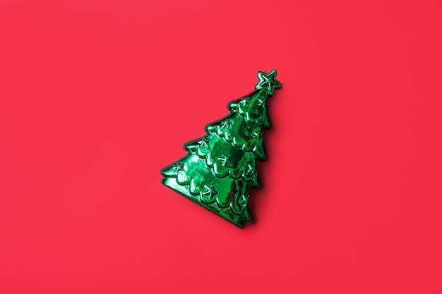 Christmas tree on red background new year holiday celebration concept