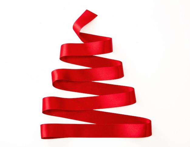 Photo christmas tree shape red ribbon isolated on white holiday decoration