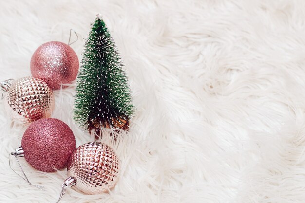 Christmas tree, toy balls on a fluffy white background.