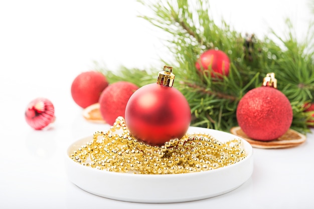 Christmas tree toys on a Christmas tree branch isolated on a white background, selective focus, copy space