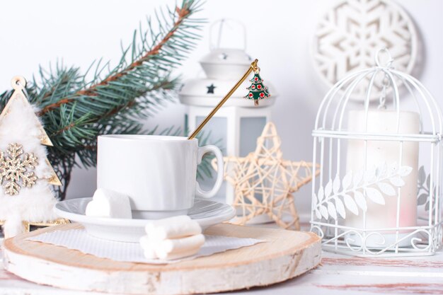 Christmas tree toys on the table with a cup of morning tea Christmas background in white tones