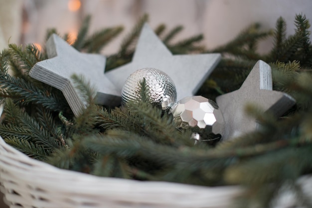 Christmas tree toys in a white wicker basket