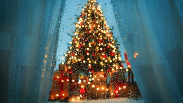 Christmas tree behind wet glass