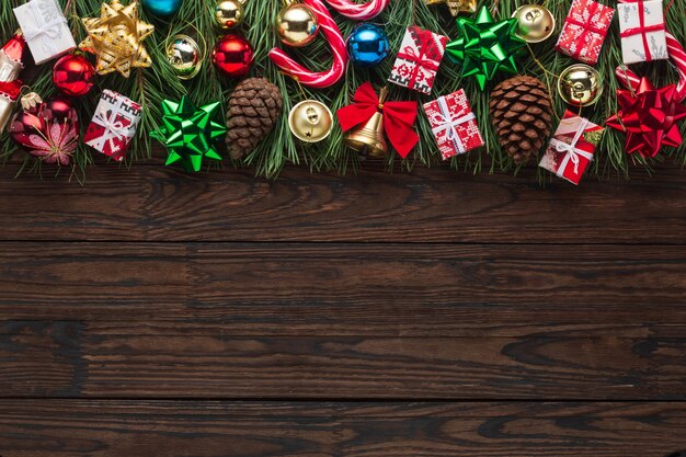 Christmas tree with decoration on a dark wooden board, frame, background