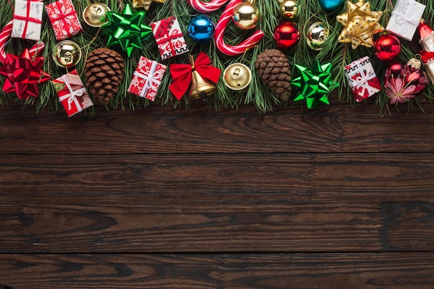 Christmas tree with decoration on a dark wooden board, frame, background