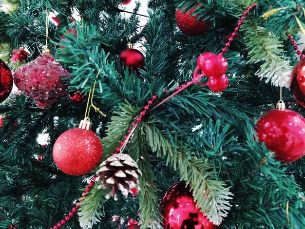 Christmas tree with decorations Christmas balls and toys Red and white hanging ornaments Beautiful balls bright berries and cones