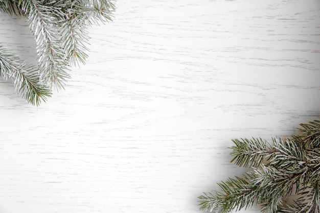 Christmas tree with frost on old wooden table