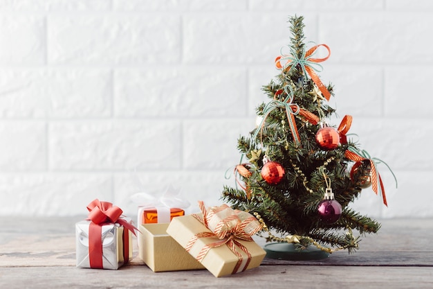 christmas tree with gift box on wooden table