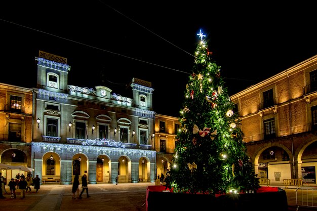 Christmas Tree with lights glowing on a town square in Avila Spain