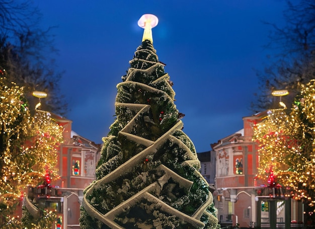 Christmas tree with lights outdoors at night in Kiev Sophia Cathedral on background New Year Celebration