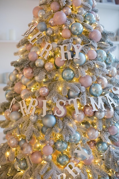 Premium Photo | Christmas tree with pink and blue decorations and ...