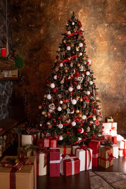 Christmas tree with presents under it and a red and white christmas tree in the background