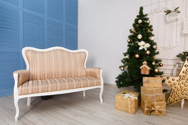 Christmas tree with presents underneath in light living room