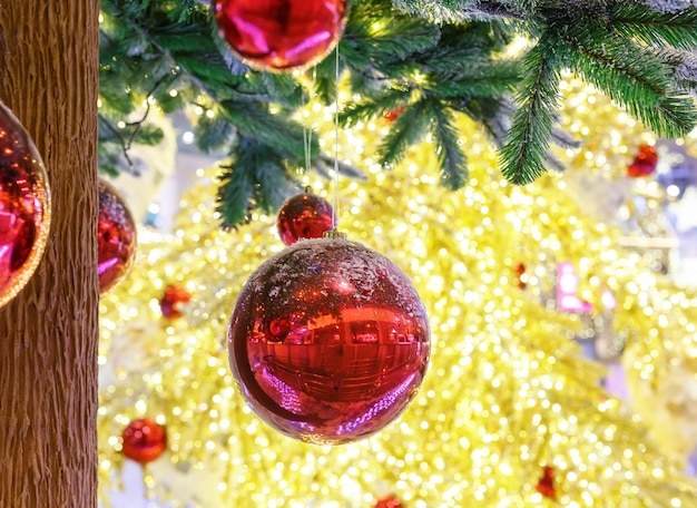 Christmas tree with red balls. Concept New Year celebration background. Closeup photo of christmas tree decorated with red balls