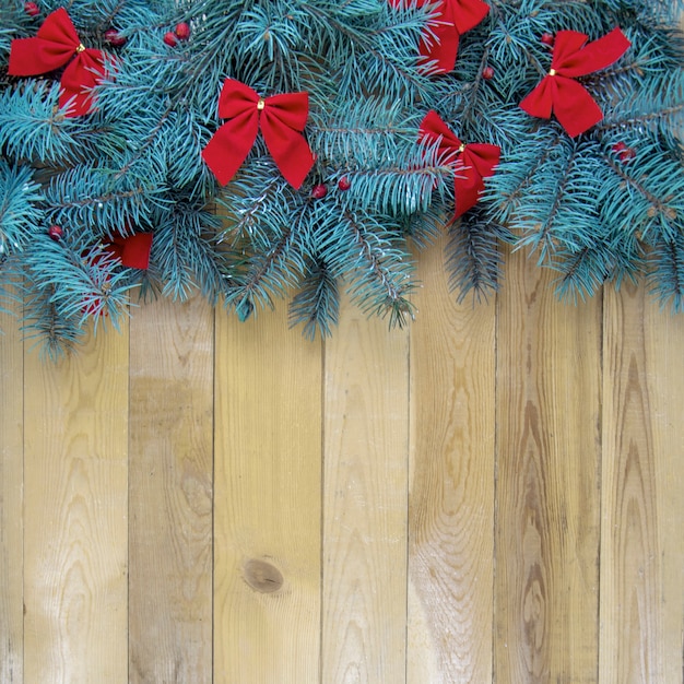 Christmas tree with red decoration on wooden