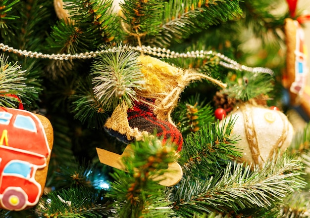 Christmas tree with red toys. Concept New Year celebration background. Closeup photo of christmas tree decorated with red toys