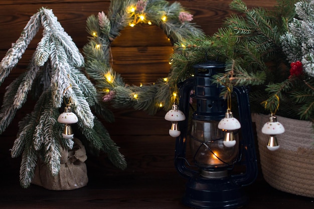 Christmas tree on a wooden background with lights Kerosene lantern romance