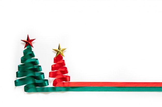 Christmas trees made from green and red ribbon with gold star on white background with coppy space