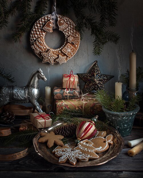 Christmas vintage decorations, toys, gifts, gingerbread cookies, and spruce on gray background