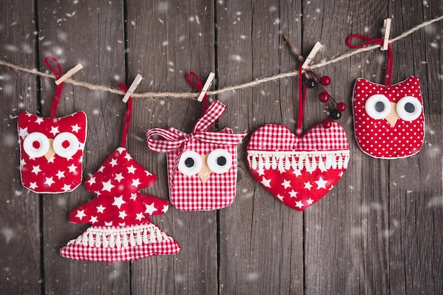 Christmas vintage ornaments hanging on string over wooden background