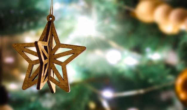 Christmas vintage wooden star shaped bauble on defocus background with copy space