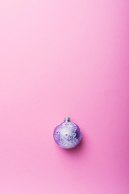 Christmas violet ball on the pink background