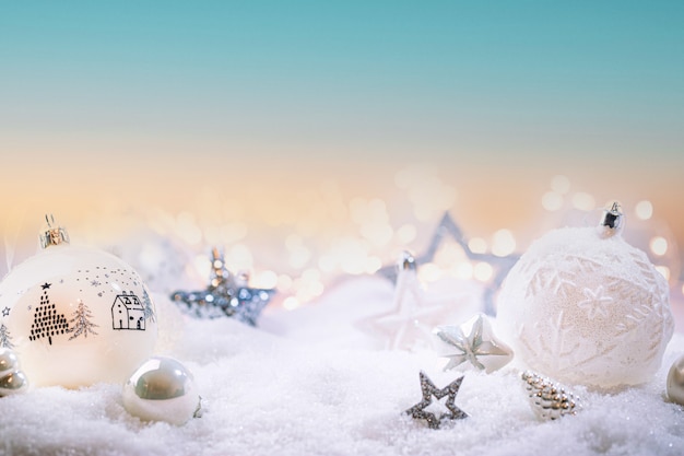 Christmas white decorations on snow with christmas lights winter decoration background