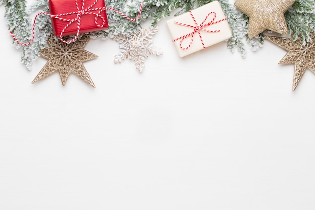 Christmas white Fir tree branches with gold stars decorations.