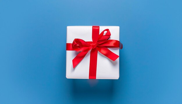 Christmas white gift with red ribbon on blue background xmas holiday boxing day