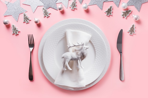 Christmas white table setting on pink.